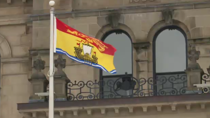 The New Brunswick flag flies outside the provincial legislature in Fredericton.