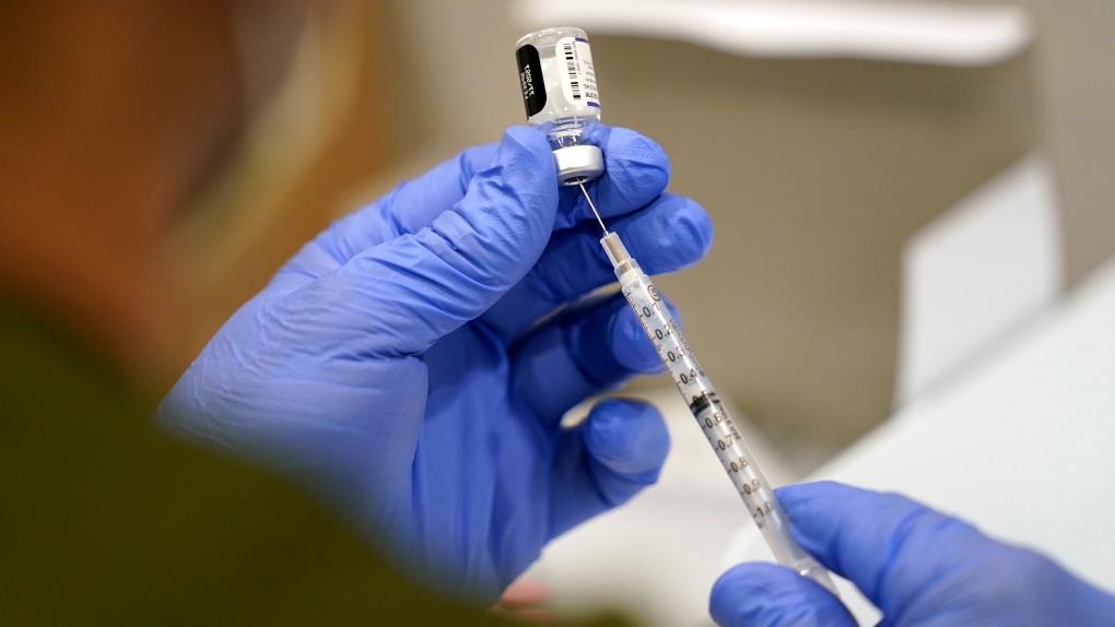 FILE - In this Oct. 5, 2021, file photo a healthcare worker fills a syringe with the Pfizer COVID-19 vaccine at Jackson Memorial Hospital in Miami. (AP Photo/Lynne Sladky, File) 