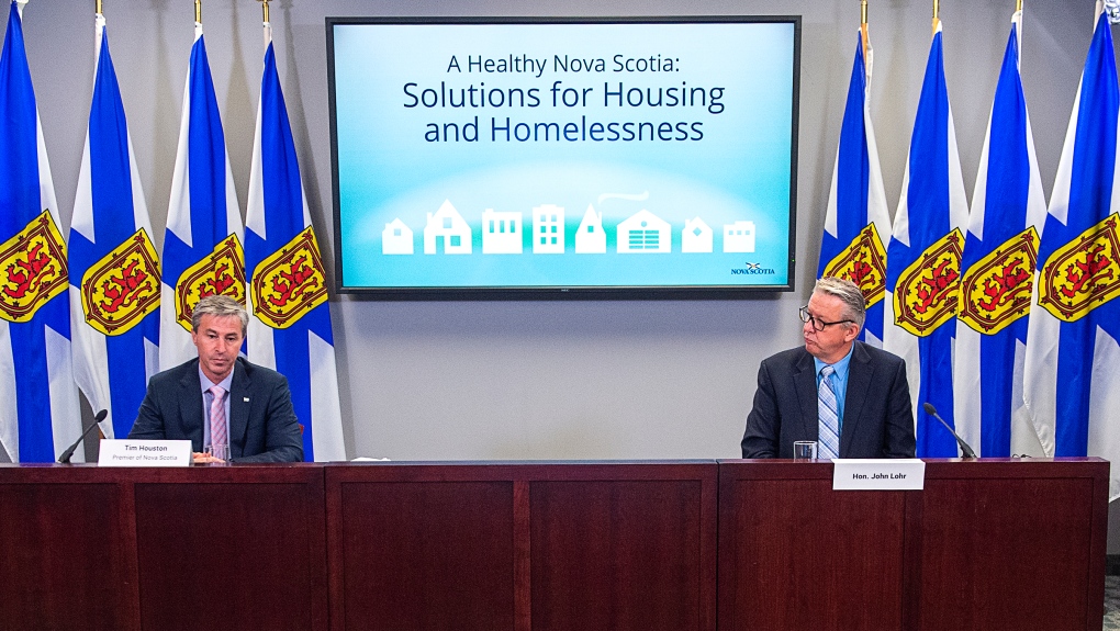 Nova Scotia Premier Tim Houston, left, accompanied by Housing Minister John Lohr, delivers his housing plan in Halifax on Wednesday, Oct. 20, 2021. (THE CANADIAN PRESS/Andrew Vaughan) 