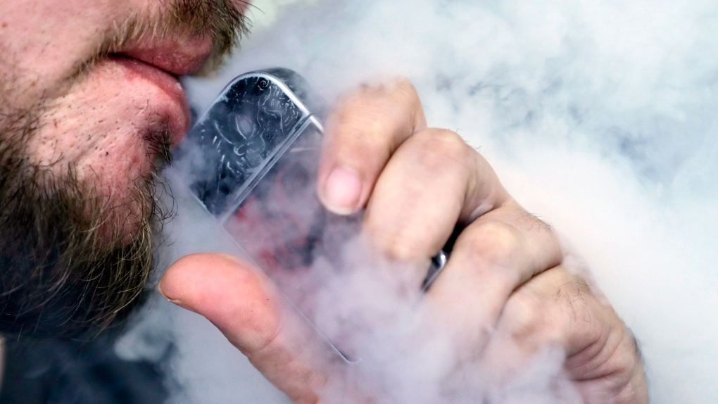 A man using an electronic cigarette exhales in Mayfield Heights, Ohio, Friday, Oct. 4, 2019. (THE CANADIAN PRESS/AP-Tony Dejak)