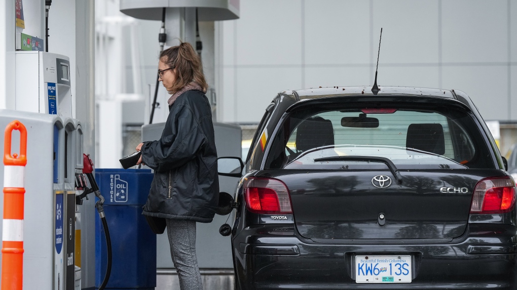 A person prepares to fuel up a car at a Shell gas station in Vancouver on Saturday, May 14, 2022. (THE CANADIAN PRESS/Darryl Dyck) 