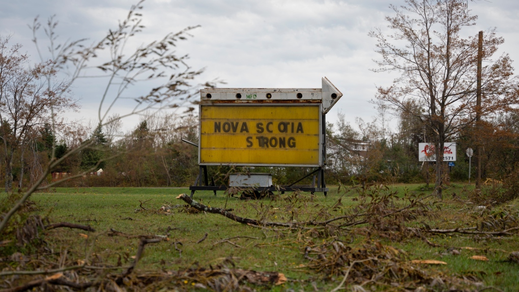 A sign depicting a hopeful message is seen amidst downed tree limbs near Lower Barneys River in Pictou County, N.S. on Wednesday, September 28, 2022 following significant damage brought by post tropical storm Fiona. THE CANADIAN PRESS/Darren Calabrese