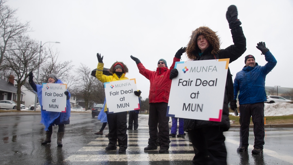 Members of Memorial University Faculty Association wave to supporters as they man a picket line on Prince Philip Drive on the first day of their strike, Monday, January 30, 2023 in St. John’s. THE CANADIAN PRESS/Paul Daly