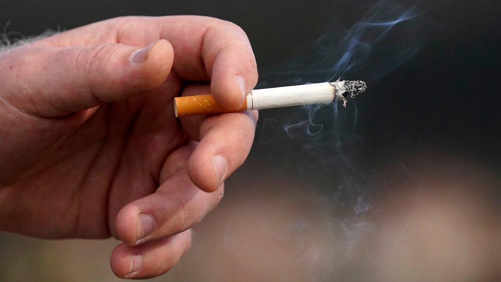 A man holds a lit cigarette. (Source: THE CANADIAN PRESS/AP, Jeff Chiu)