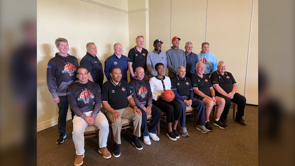 NCAA coaches, officials, tournament organizers, and City of Moncton officials get together for a photo. (CTV/Derek Haggett)