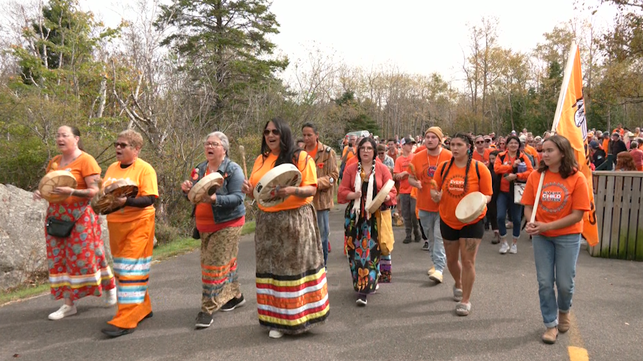 A large crowd marches through the Great Canadian Trail at Rockwood Park in Saint John, N.B. (CTV/Avery MacRae)