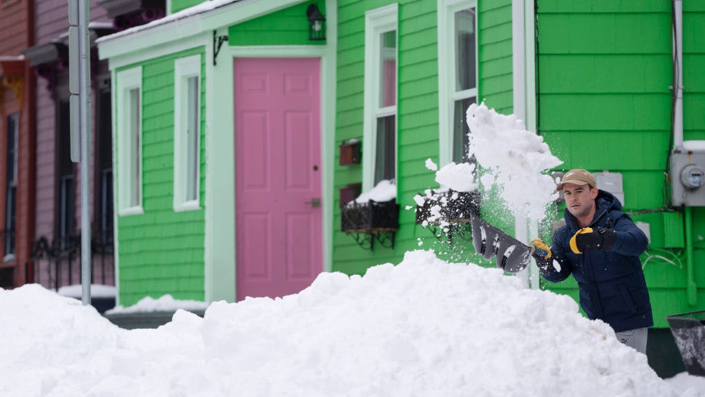 A person shovels snow in Halifax on Monday, February 5, 2024. Many Nova Scotians were digging out after a historic snowfall dropped as much as 150 cm of snow in some parts of the province. THE CANADIAN PRESS/Darren Calabrese