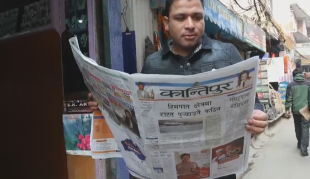 guy reading newspaper in Nepal